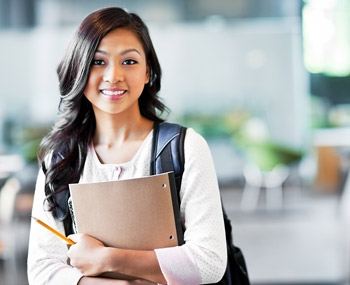 student holding books – school placement services